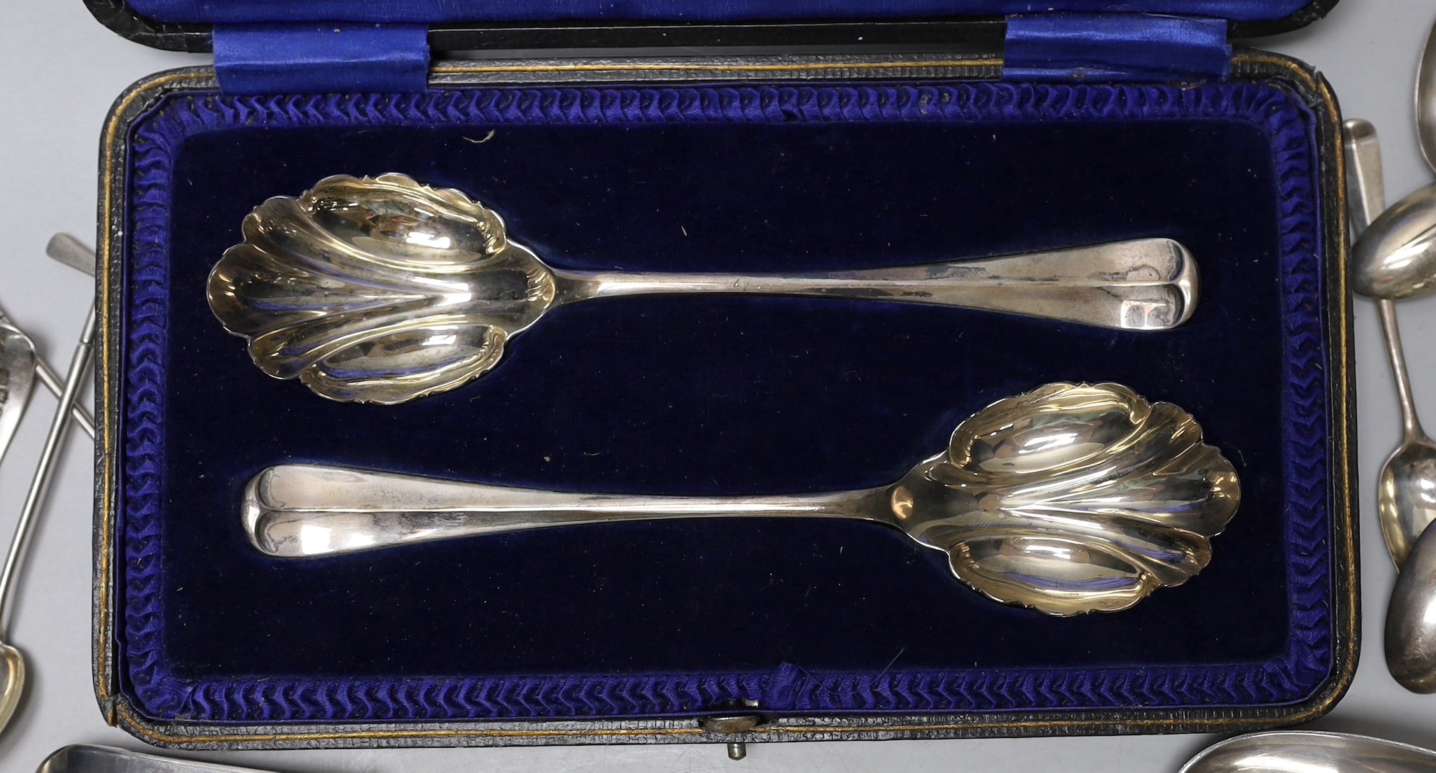 A Victorian Irish silver fiddle pattern basting spoon, Dublin, 1844, three George III tablespoons, a pair of later cased serving spoons and sundry tea, coffee and golf spoons, 23.7oz.